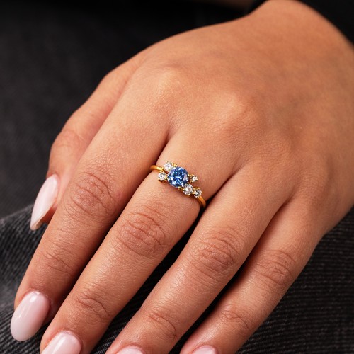 Round Gemstone Ring with Scattered Side Stones – 10K Yellow Gold with Ice Blue Sapphire and Cubic Zirconia