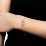 Interlocking Heart Promise Bracelet with Two Stones – 18K Gold Plated Silver with Emerald